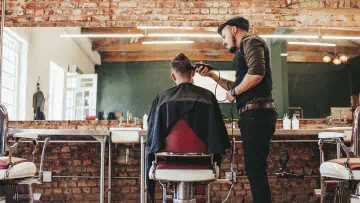 Professional barber cutting client's hair